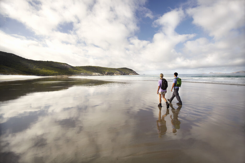 Couple walking along beach in Wilsons Promontory National Park